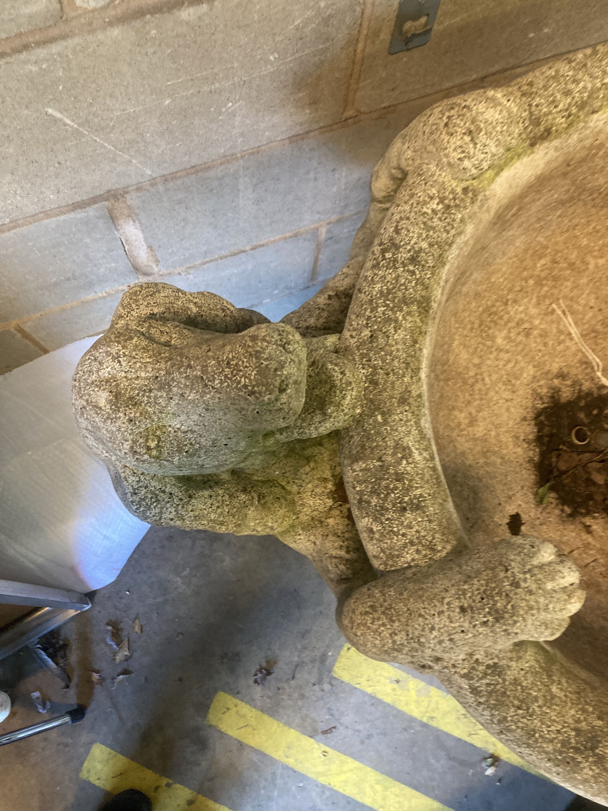 A reconstituted stone garden fountain modelled as a hound drinking from a circular bowl, width 80cm height 112cm